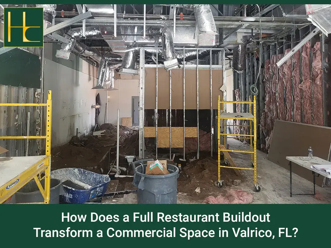 How Does a Full Restaurant Buildout Transform a Commercial Space in Valrico, FL? Interior of a commercial space under construction with exposed ductwork, insulation, and scaffolding for restaurant buildout